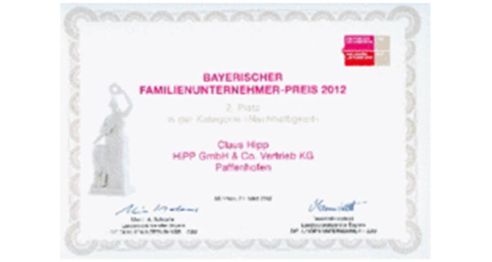 A certificate with a red stamp, signatures, and printed text, indicating an award or recognition.