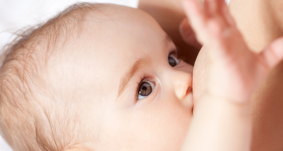 A close-up of a baby's face, with one eye visible, looking towards the camera.