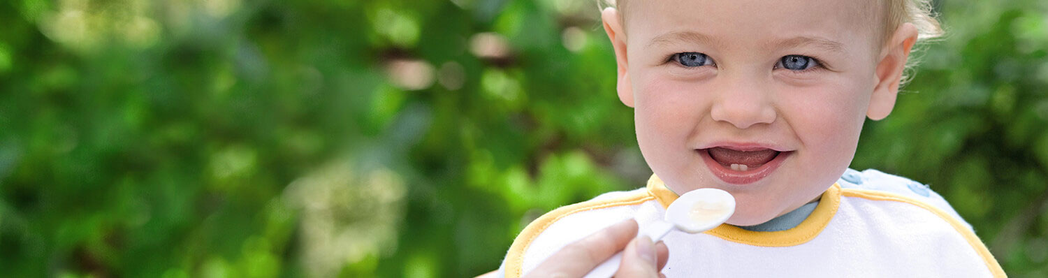 A child is being fed with a spoon.