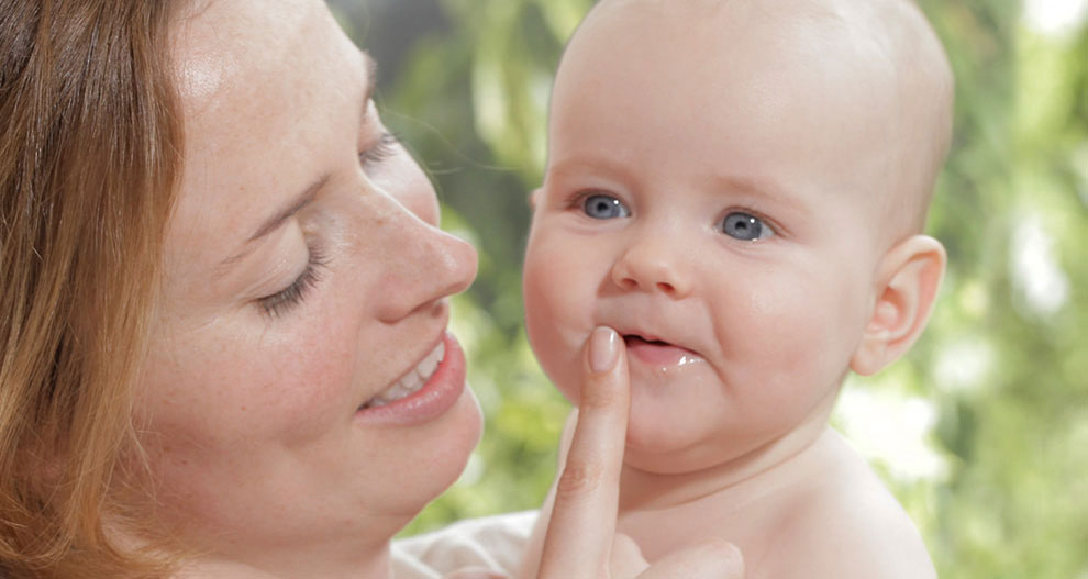 A woman and a baby share a tender moment.