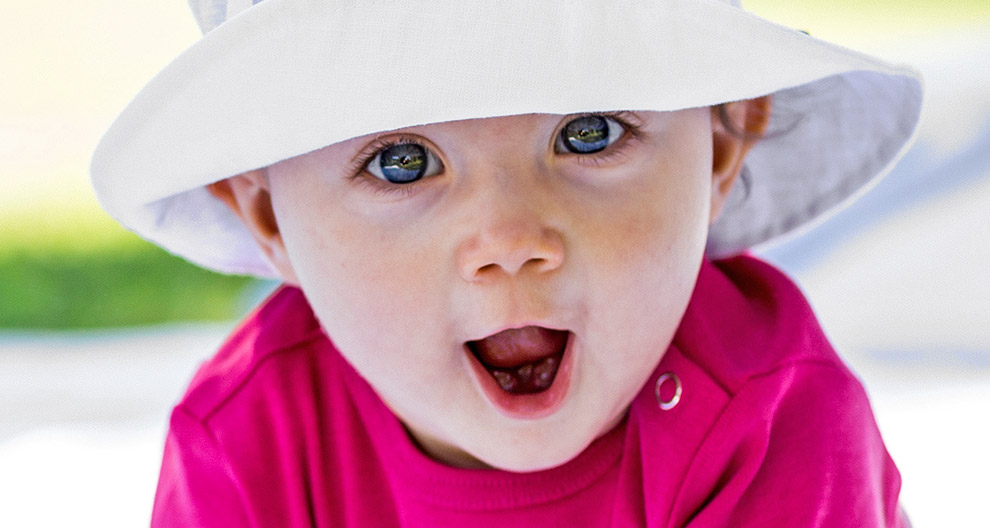 Baby, hat, eyes, mouth, pink shirt.